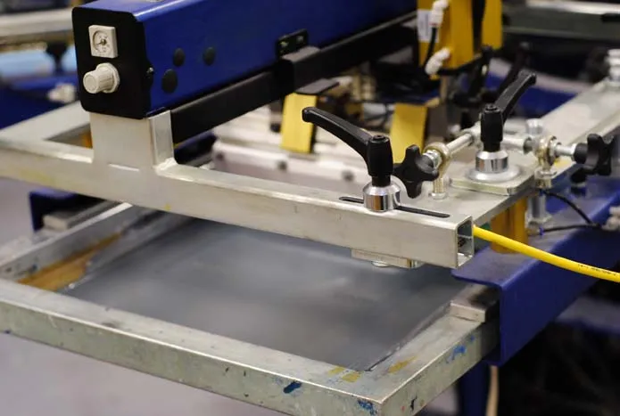 Industrial screen printing machine showing ink application process for industrial substrates